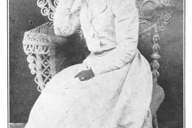 Public domain photo of Effie Waller Smith in a white dress, seated with one hand near her mouth and the other hand on her lap.