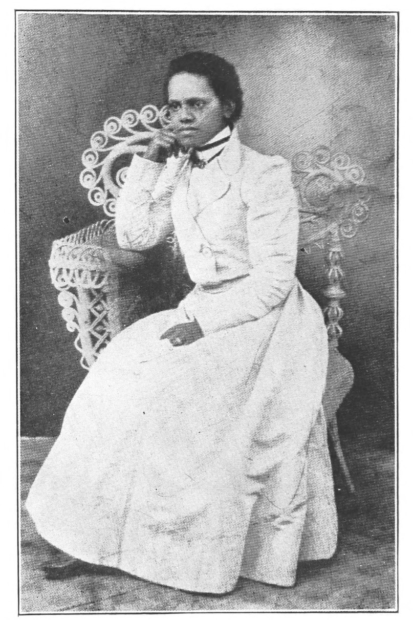 Public domain photo of Effie Waller Smith in a white dress, seated with one hand near her mouth and the other hand on her lap.